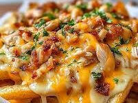 Chicken cheese loaded fries with melted cheddar sauce, crispy bacon, jalapeños, and fresh cilantro on golden crinkle-cut fries