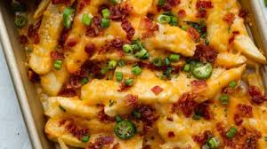 Chicken cheese loaded fries with melted cheddar sauce, crispy bacon, jalapeños, and fresh cilantro on golden crinkle-cut fries